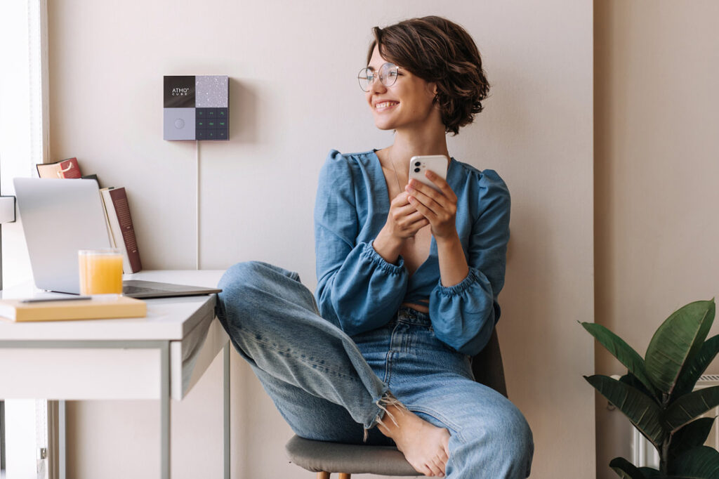 A woman in a room with Atmocube